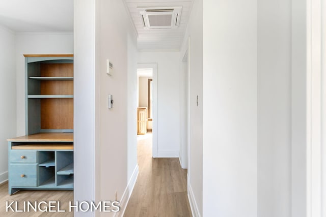 corridor with hardwood / wood-style floors and crown molding