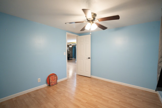 empty room featuring light wood-type flooring and ceiling fan