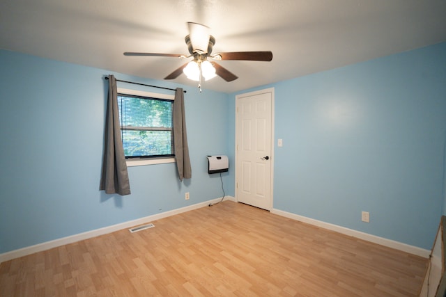 spare room featuring light hardwood / wood-style floors and ceiling fan