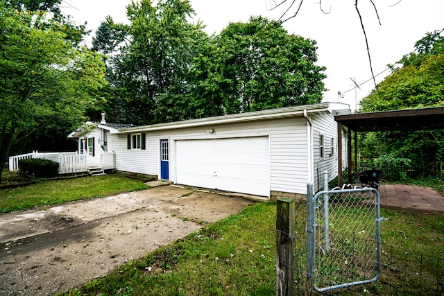 garage with a yard and a carport