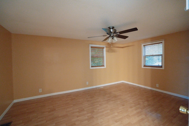 empty room with light wood-type flooring and ceiling fan