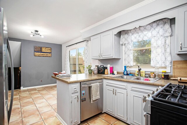 kitchen featuring kitchen peninsula, dishwasher, light tile patterned floors, and white cabinets