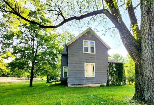 view of home's exterior with a yard