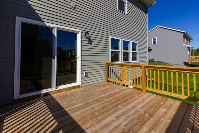 wooden deck featuring a yard