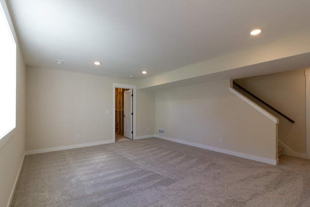 spare room featuring light colored carpet