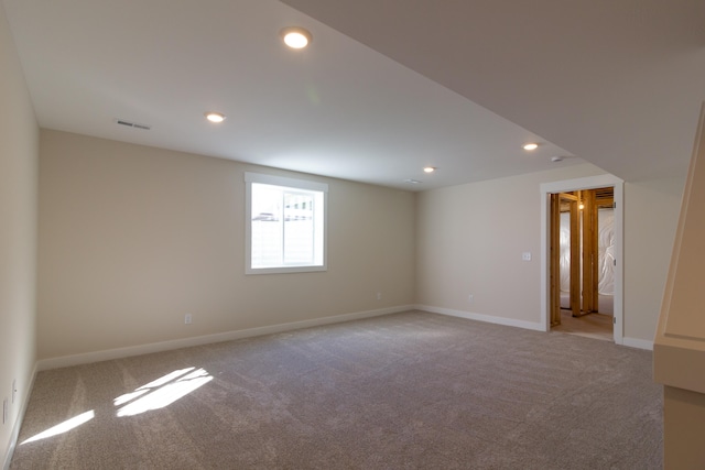 unfurnished room featuring light colored carpet