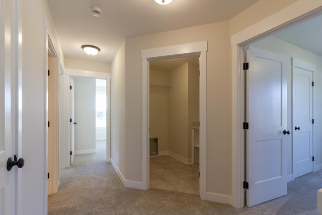 hallway featuring light carpet