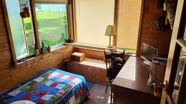 carpeted bedroom with wooden walls