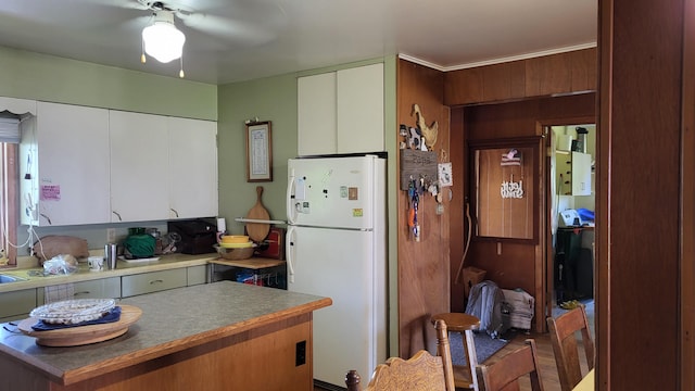 kitchen with ceiling fan, white cabinets, white refrigerator, and dark wood-type flooring