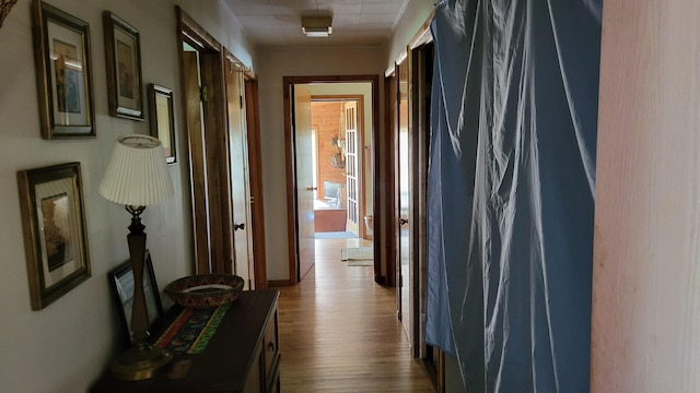 hallway with hardwood / wood-style flooring