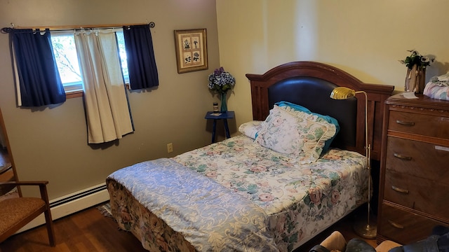 bedroom featuring dark hardwood / wood-style flooring and a baseboard heating unit