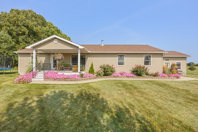 single story home featuring a trampoline and a front yard