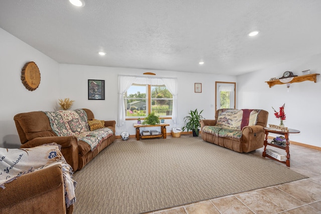 living room with a textured ceiling and light tile patterned floors