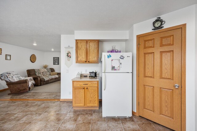 kitchen featuring a textured ceiling and white fridge