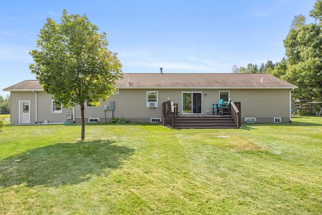 back of house featuring a deck and a lawn