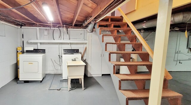 basement featuring sink and washing machine and dryer