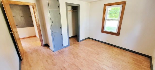 unfurnished bedroom featuring a closet and light hardwood / wood-style flooring