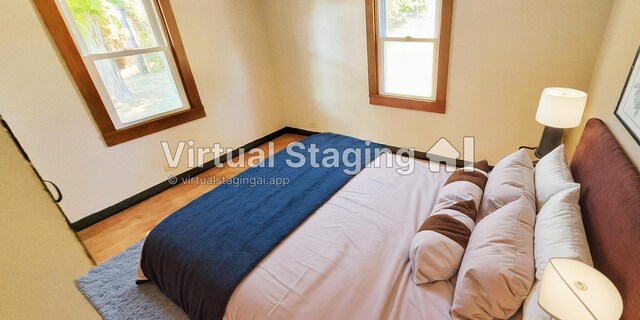 bedroom featuring multiple windows and hardwood / wood-style floors