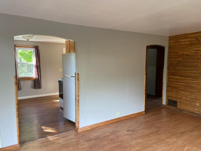 unfurnished room with hardwood / wood-style flooring