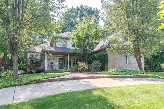 view of front of property with a porch and a front lawn