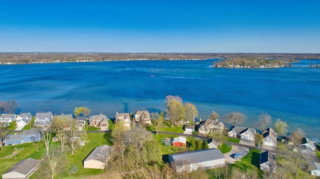 drone / aerial view with a water view and a residential view