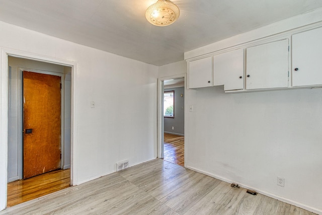 unfurnished room with light wood-type flooring