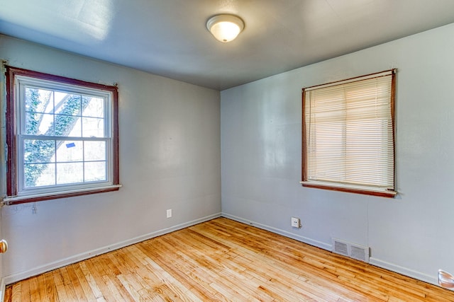 empty room with light hardwood / wood-style flooring