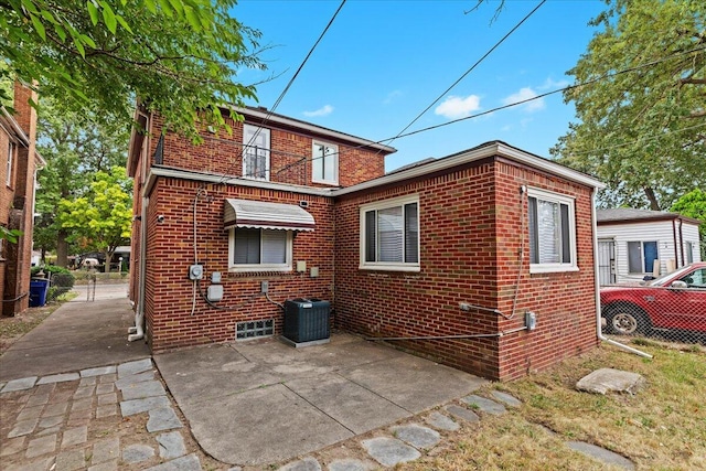 back of property featuring cooling unit and a patio area