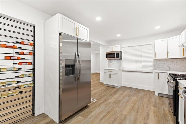 kitchen with white cabinets and appliances with stainless steel finishes