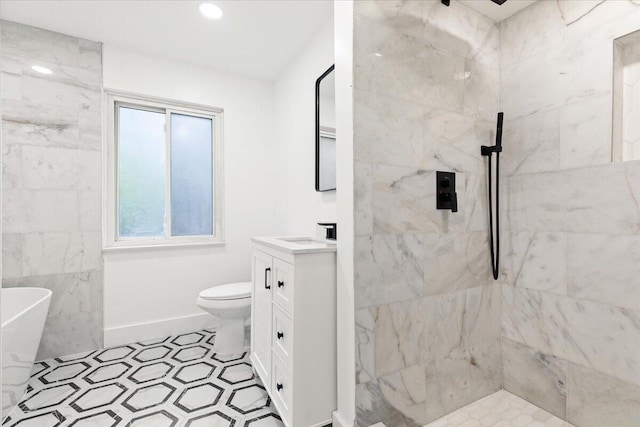 bathroom with a healthy amount of sunlight, tiled shower, vanity, and toilet