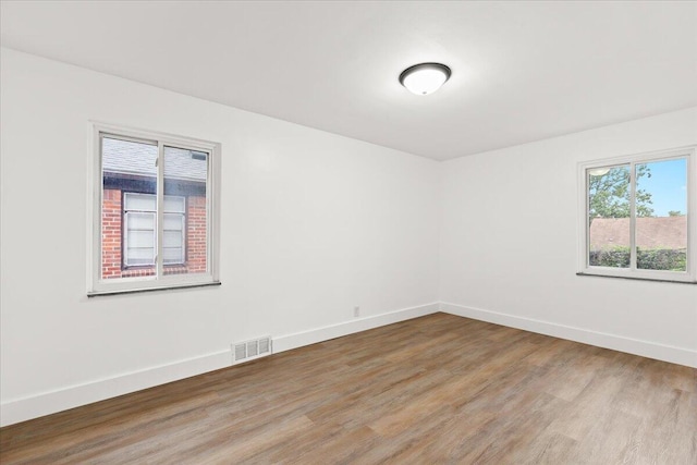 spare room with wood-type flooring