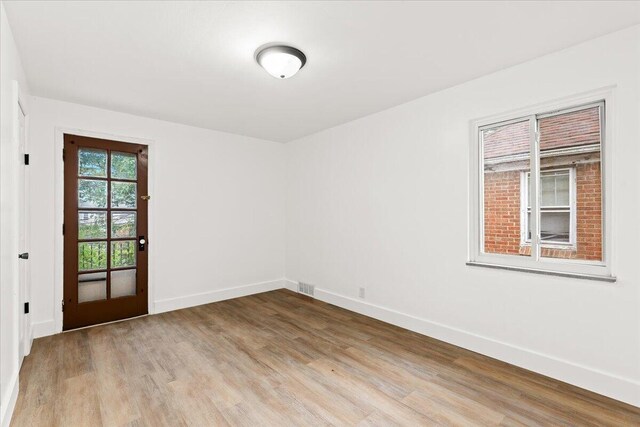 spare room featuring light hardwood / wood-style flooring