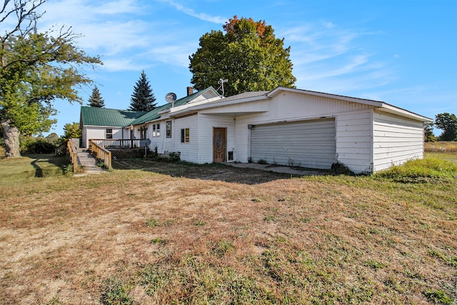 back of house with a wooden deck and a yard