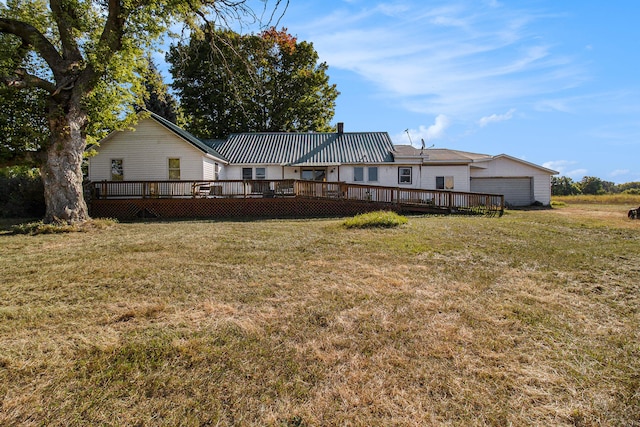 rear view of house with a deck and a lawn