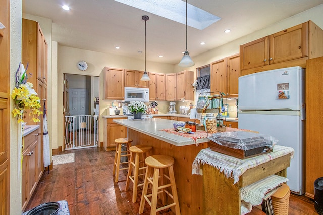 kitchen featuring a skylight, a center island, tasteful backsplash, dark hardwood / wood-style floors, and white appliances