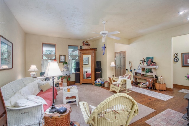 living room featuring hardwood / wood-style flooring and ceiling fan