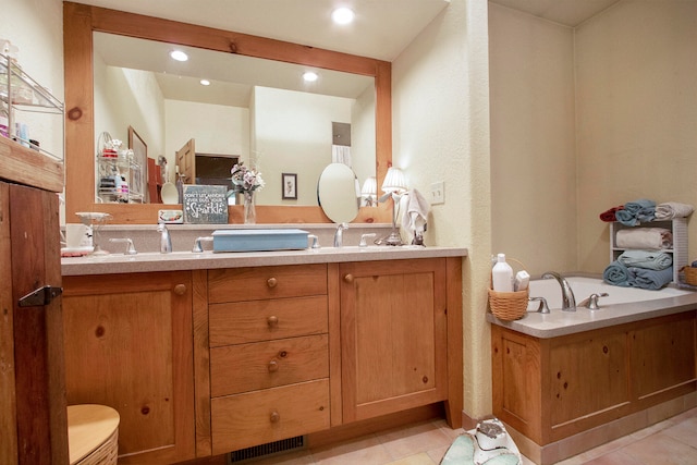 bathroom with tile patterned flooring and vanity