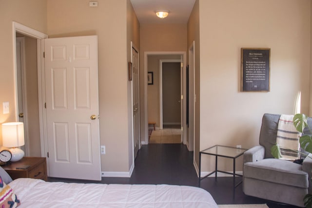 bedroom with dark hardwood / wood-style flooring