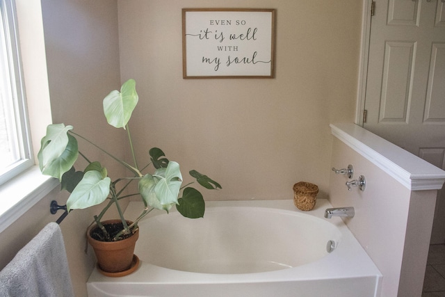 bathroom featuring a washtub