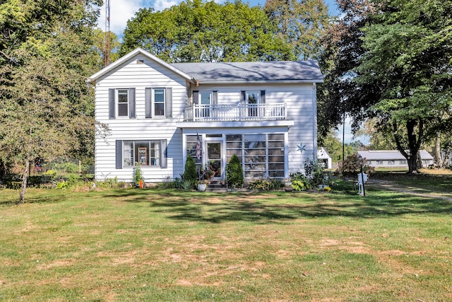 view of front of property featuring a front lawn and a balcony