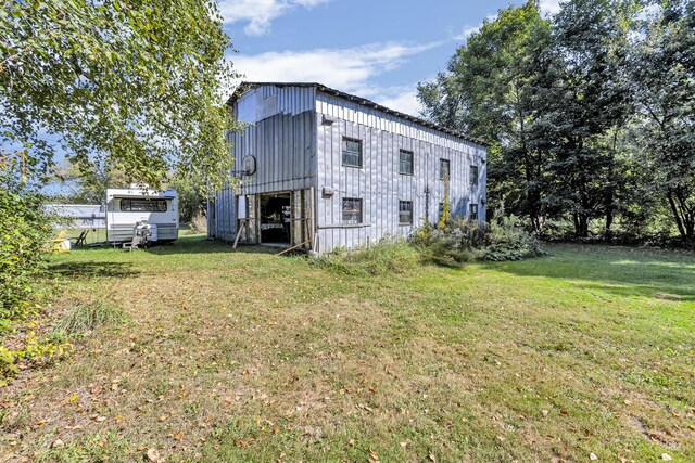 rear view of house featuring a yard