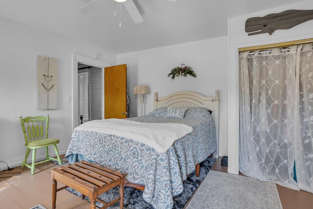 bedroom with ceiling fan, a closet, and wood-type flooring