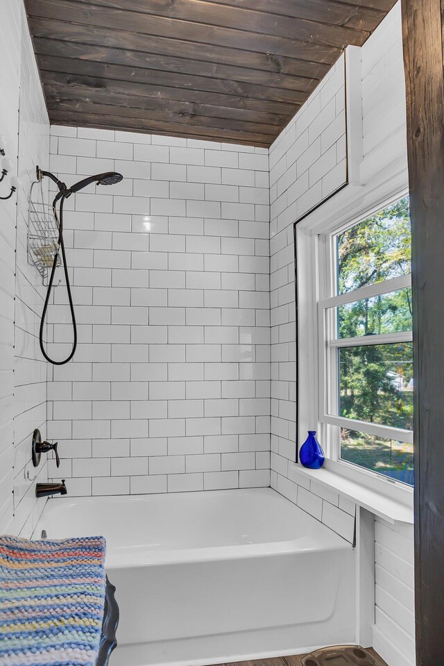 bathroom with wooden ceiling and tiled shower / bath combo