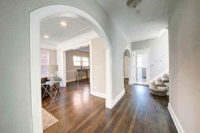 hallway featuring a textured ceiling and dark wood-type flooring