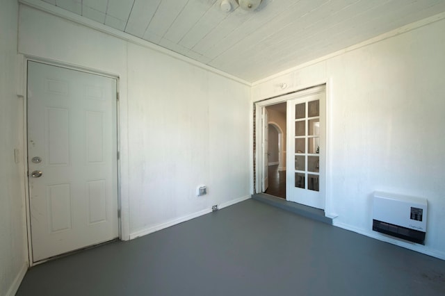 spare room featuring french doors and heating unit