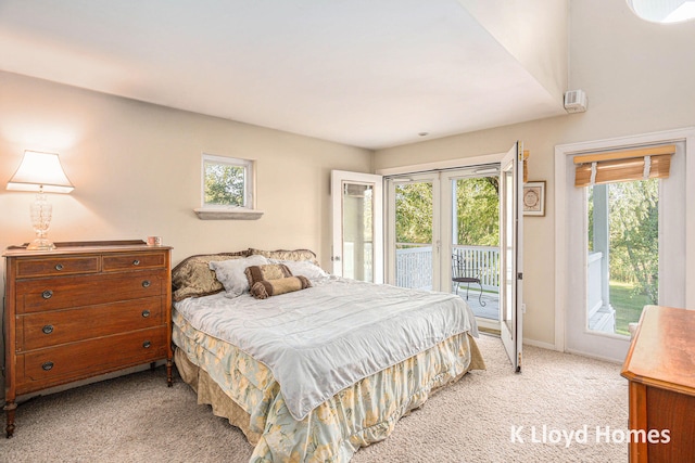 bedroom featuring light colored carpet and access to exterior