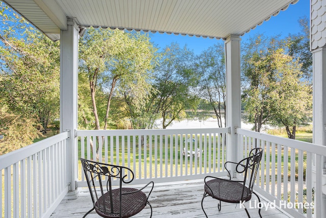 wooden deck featuring a water view