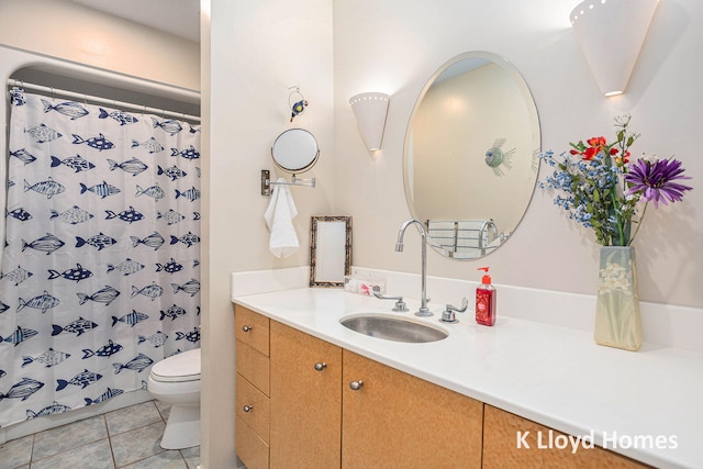 bathroom with a shower with shower curtain, tile patterned floors, vanity, and toilet