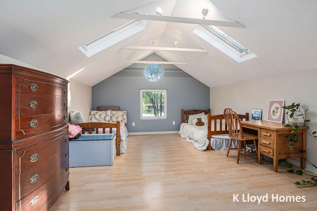 bedroom featuring light hardwood / wood-style flooring and lofted ceiling with skylight