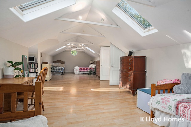 bedroom with light hardwood / wood-style floors, lofted ceiling with skylight, and ceiling fan